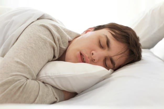 tired young man sleeping bed home 392895 6985