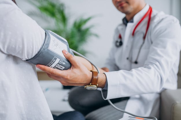 young male psysician with patient measuring blood pressure 1303 17877